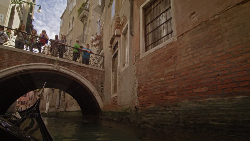 VENICE, ITALY - MAY 2, 2012: Gondola ride through a back alley canal toward a