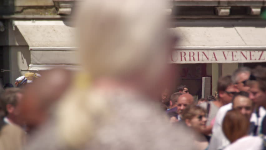 VENICE, ITALY - MAY 2, 2012: Slow motion shot of crowded street below awning