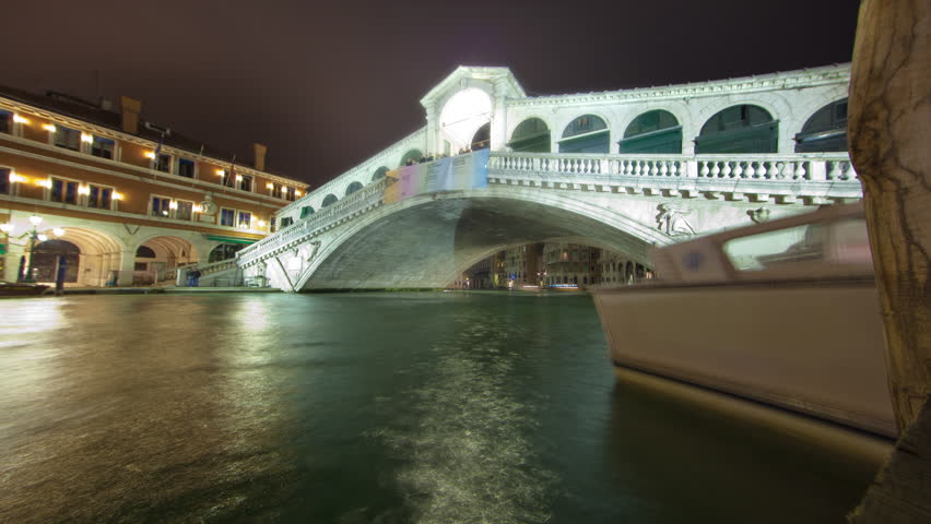 VENICE, ITALY - CIRCA MAY 2012: Rialto bridge time-lapse from side of canal.