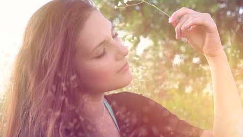 Beautiful Girl Lying on the Meadow. Enjoying Nature. Beauty Woman outdoors. Spring Field. Close up Slow Motion Footage 1920x1080p. Slowmo. High Speed camera shot