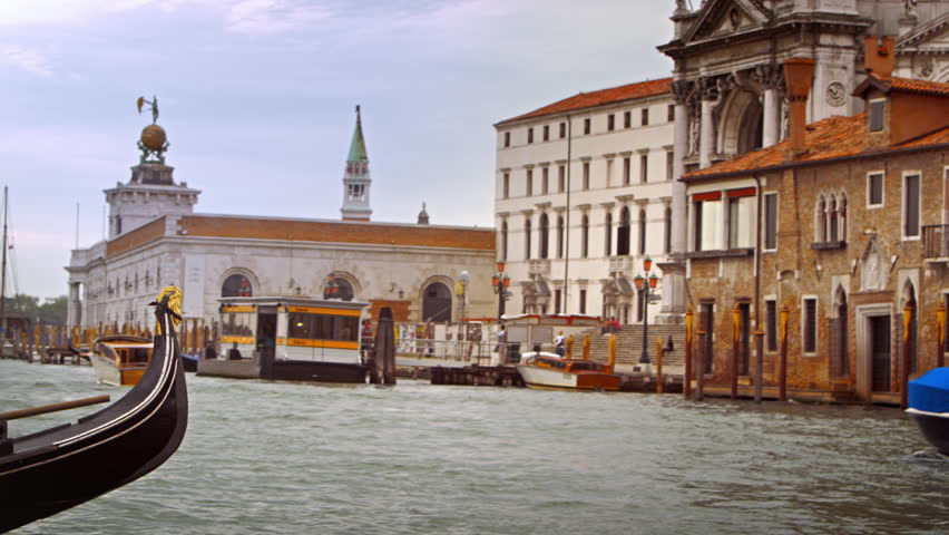 VENICE, ITALY - MAY 2, 2012: Gondolier steers a gondola near Santa Maria della