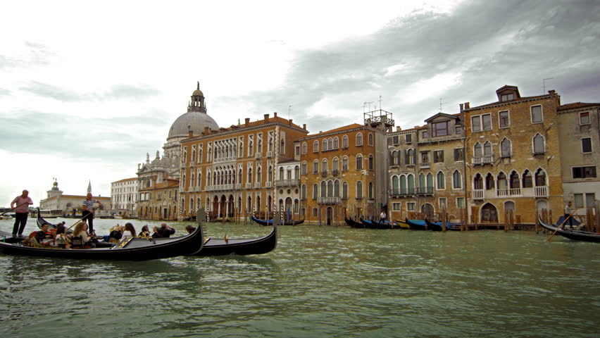 VENICE, ITALY - MAY 2, 2012: Gondolas on a canal near Santa Maria della Salute
