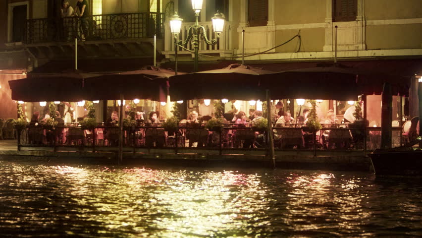 VENICE, ITALY - MAY 2, 2012: Restaurant seating area on the waterside at night