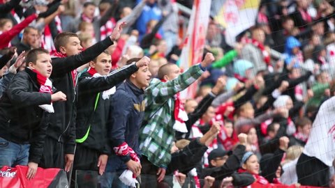 MOSCOW, RUSSIA - SEP 9, 2012: Young fans shout at football match Spartak Moscow - Dynamo Kiev at Lokomotiv stadium.