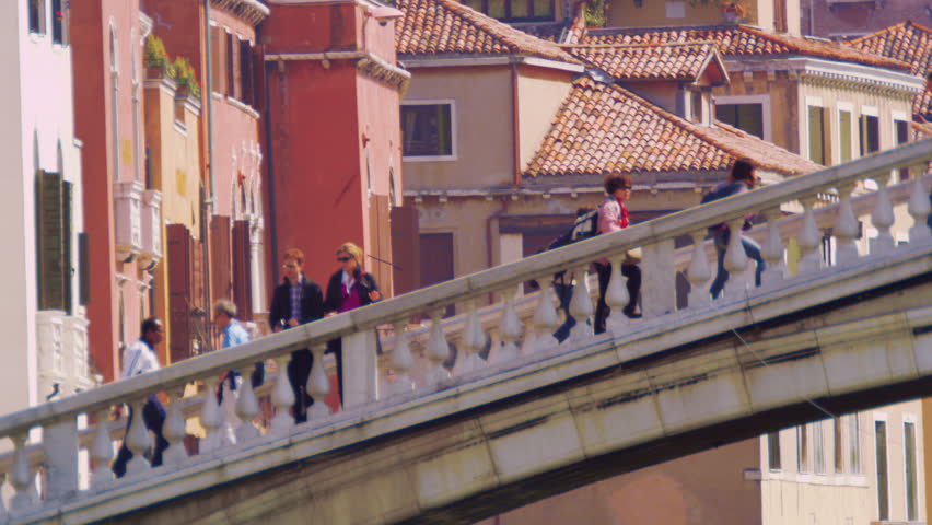 VENICE, ITALY - MAY 4, 2012: Slow motion shot of a couple talking on the Ponte