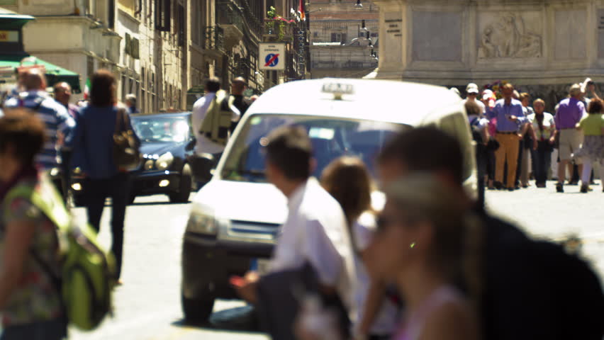 ROME, ITALY - MAY 5, 2012: Slow motion footage of pedestrians and a car on a