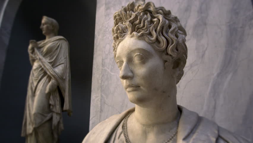 ROME, ITALY - MAY 5, 2012: Profile of female bust with statue in background.