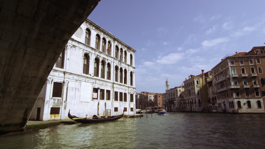 VENICE, ITALY - MAY 4, 2012: Tracking shot emerging from underneath Rialto
