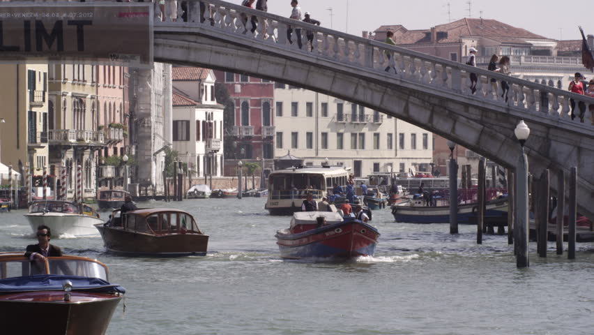 VENICE, ITALY - MAY 4, 2012: Slow motion shot of motor boats traversing the