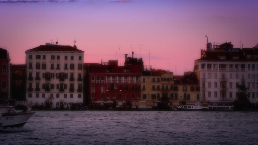 VENICE, ITALY - MAY 3, 2012: Buildings across the canal with dome in background