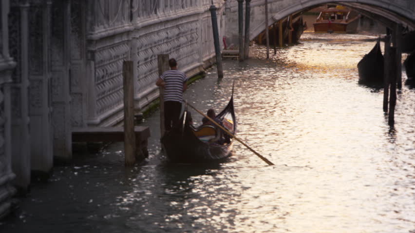VENICE, ITALY - MAY 3, 2012: Slow motion shot of gondolier navigating his
