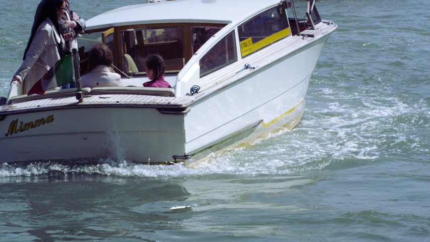 VENICE, ITALY - MAY 4, 2012: Slow motion shot of a motor boat focusing on the