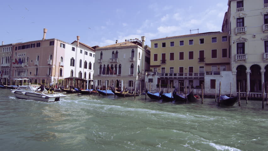 VENICE, ITALY - MAY 4, 2012: Slow motion, tracking shot of motor boat passing