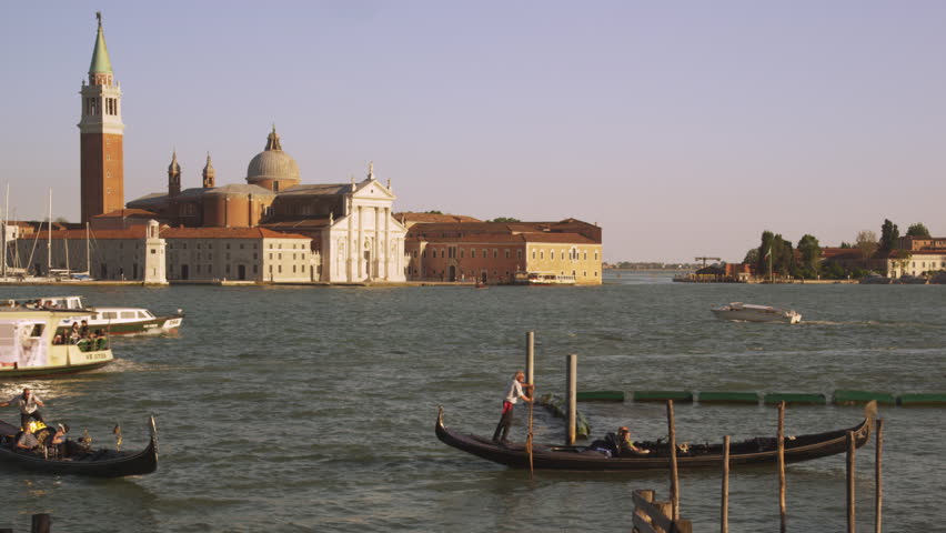 VENICE, ITALY - MAY 3, 2012: Shot of several gondolas and a vaporetto in the