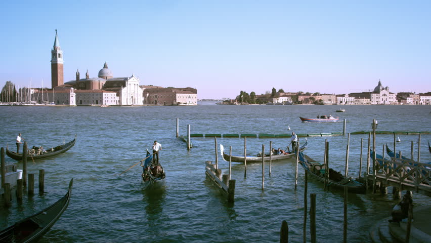 VENICE, ITALY - MAY 3, 2012: Shot of several gondolas in the canal with the