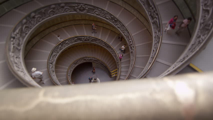 ROME, ITALY - MAY 5, 2012: Tourists descend spiral stairs in slow motion