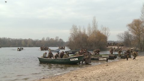 KIEV, UKRAINE - NOVEMBER 04, 2013 : 04.11.2013. Reconstruction of the hostilities of the Second world war in Kiev. The soldiers are forcing the Dnieper river near Kiev, and attack the enemy.