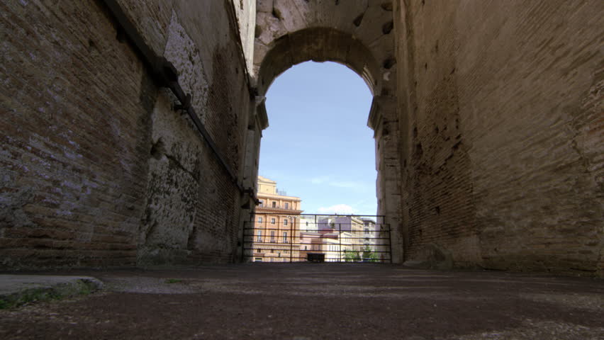 ROME, ITALY - MAY 6, 2012: Italian buildings seen through a Colosseum arch on a