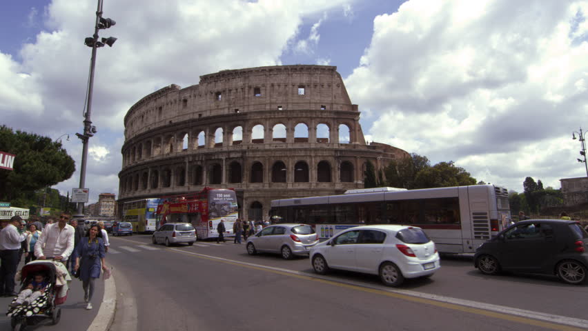 ROME, ITALY - MAY 6, 2012: Pedestrians and Traffic in front of the Colosseum in