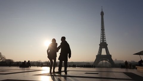 happy couple near Eiffel tower in Paris, France