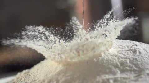 slow motion of falling eggs into flour stock footage food