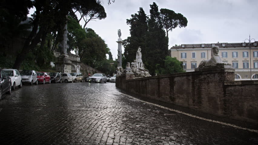 ROME, ITALY - MAY 7, 2012: Northeast wet cobble road curving around the Piazza
