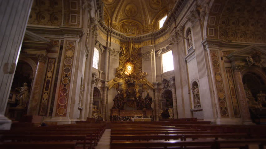 ROME, ITALY - MAY 8, 2012: Tilt up from pews to ceiling of St Peter's Basilica