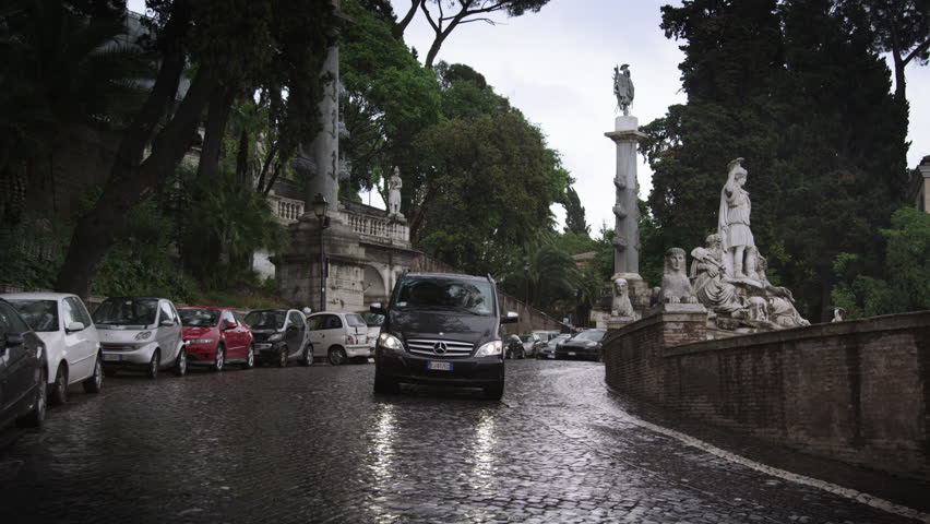 ROME, ITALY - MAY 7, 2012: Slow motion footage of cars passing the Fontana del