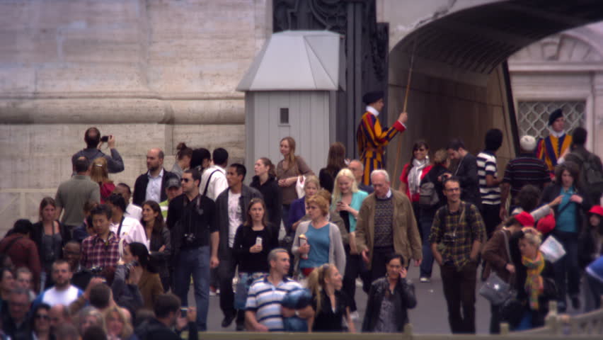 ROME, ITALY - MAY 8, 2012: Tourists watched by the Swiss Guard.