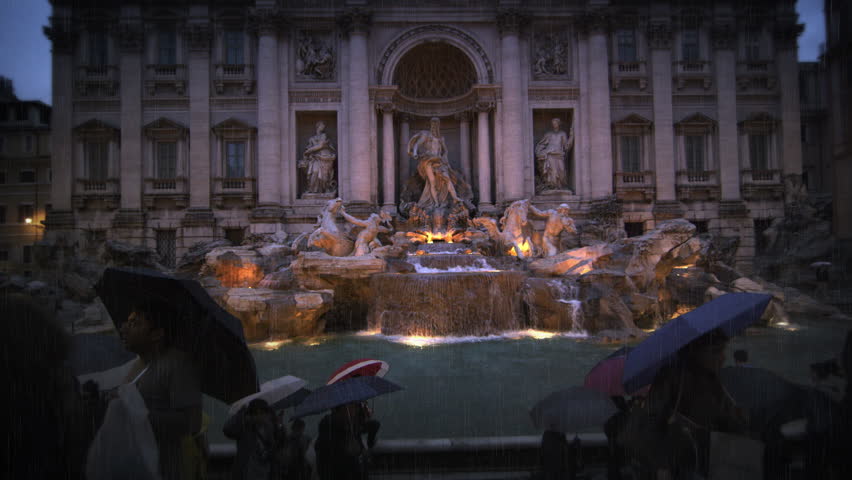 ROME, ITALY - MAY 7, 2012: Tourists visiting the Trevi Fountain at dusk in the