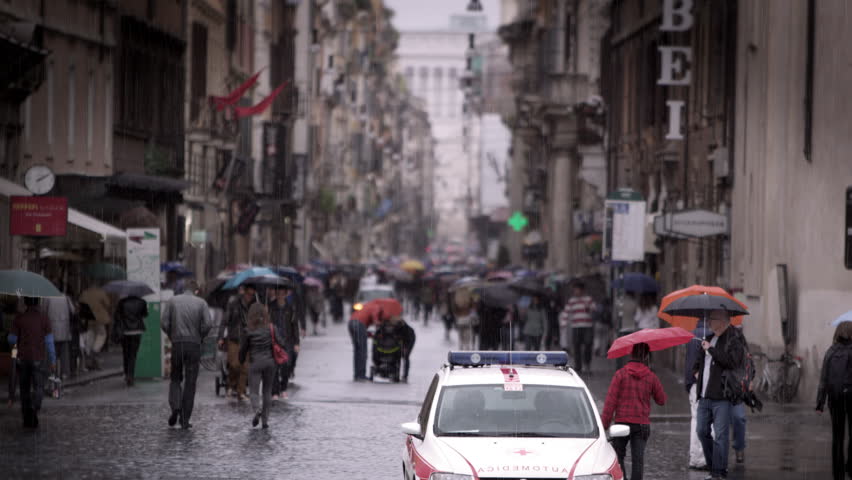 ROME, ITALY - MAY 7, 2012: Slow motion footage of people walking down a wet