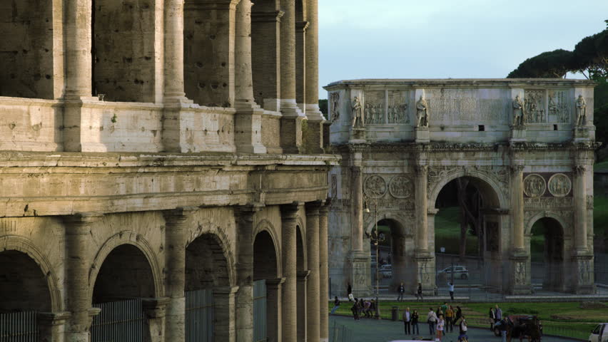 ROME, ITALY - MAY 6, 2012: Shot of Arch of Constantine with Colosseum in the