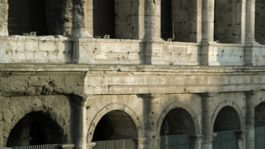 ROME, ITALY - MAY 6, 2012: Panning shot close up of Colosseum to Arch of