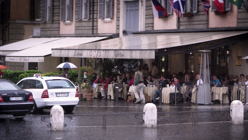 ROME, ITALY - MAY 7, 2012: Covered roman cafe filled with people eating