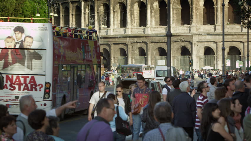ROME, ITALY - MAY 6, 2012: Slow motion shot of Colosseum with traffic and crowd