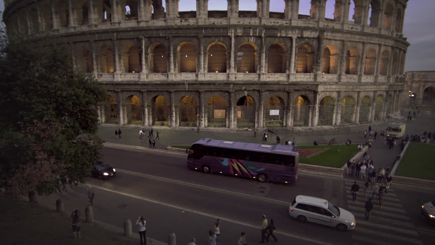 ROME, ITALY - MAY 6, 2012: Cars and buses on street in front of Colosseum and
