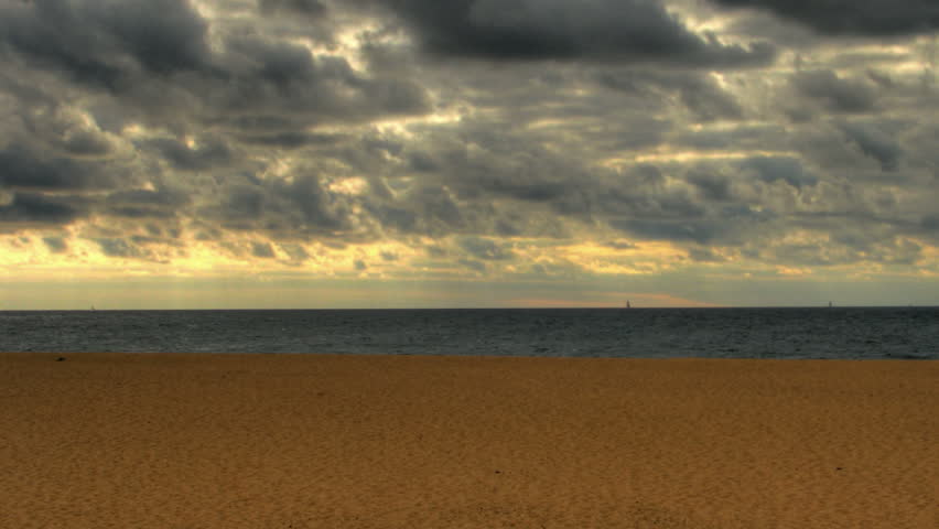 Storm clouds over atlantic ocean beach, HD time lapse clip, high dynamic range