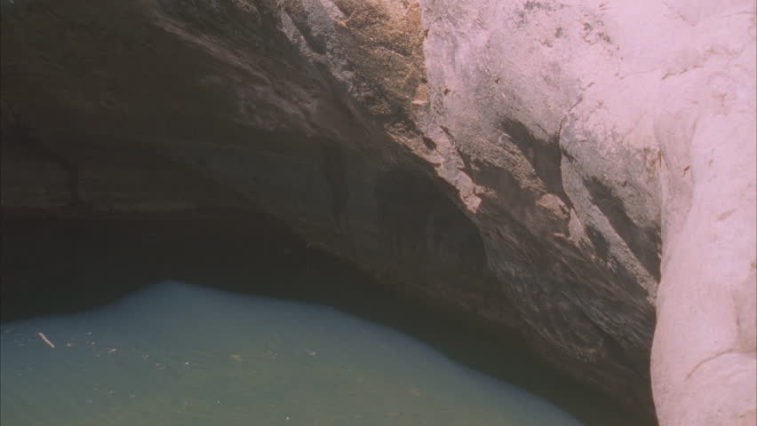 Water in rock pool reflecting on a rock