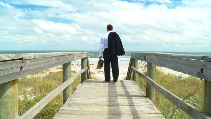Smart young businessman taking time out from the office on the beach 60 FPS