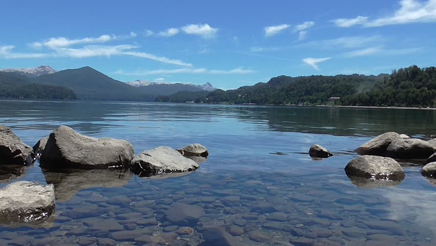 Serene view of a beautiful lake in the south of Argentina. Lake, Mountains and Stones. Great for relaxing, vacations, travel, outdoors situations