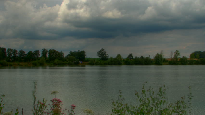 Storm clouds over lake, HD motion time lapse clip, high dynamic range imaging