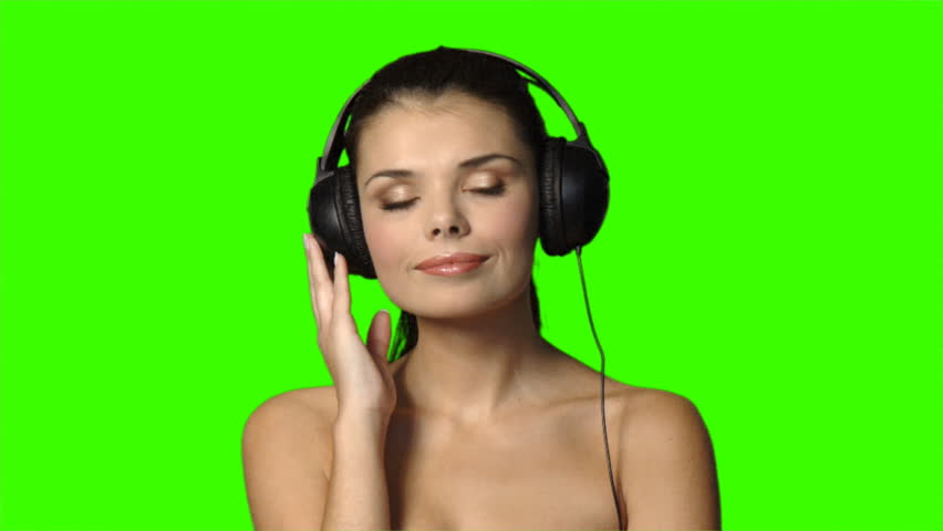 Portrait of beautiful and sexy woman listen to music in headphones 