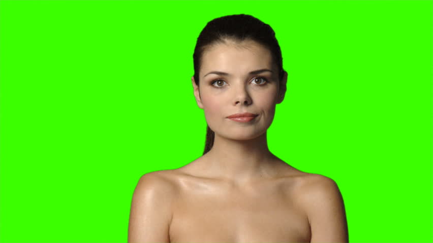 Sexy woman on green screen is showing thumb down gesture 
