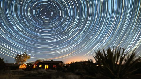 4K Star Trails Night Sky Cosmos Galaxy Time-lapse over Cabin. Sunrise from night to day in amazing high resolution at Joshua Tree National Park, California. 