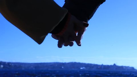 Detail of two lovers joining hands in ISTANBUL