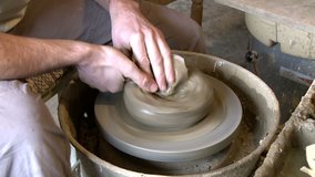 Artist shaping a bowl on a pottery wheel