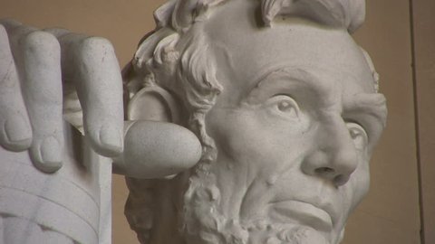 A low angle close up and zoom out of the Abraham Lincoln statue in Washington DC.