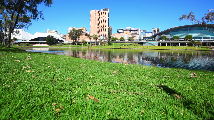 Motorized vertical dolly shot of Adelaide city, South Australia, with Torrens river in foreground