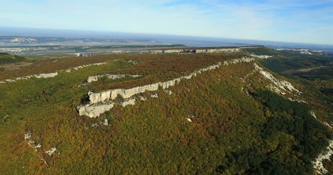Aerial View: Chufut-Kale fortress. Mountain plateau of Burunchak. Chufut-Kale is a national monument of Crimean Karaite culture and Tatar fortress in Crimea, near Bakhchisaray. Crimea. Autumn 2013.