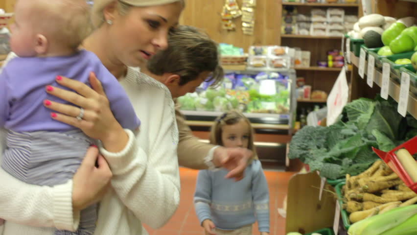 Daughter helps parents to buy food in farm shop.Shot on Canon 5D MkII at a frame rate of 25fps